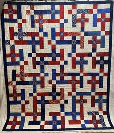 a red, white and blue quilt on display