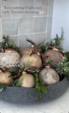 a bowl filled with ornaments sitting on top of a counter