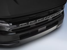 the front end of a black car on a white background