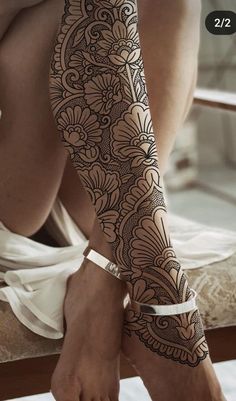 a woman's legs with hendix and flowers on the leg, showing her tattoo