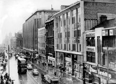 an old black and white photo of a city street