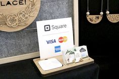 a display case for square credit cards and earring holders with the logo on it