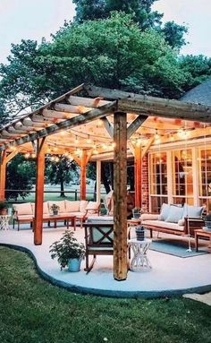 an outdoor patio with lights on the roof and seating area in the middle of it