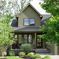 a house that has some plants in front of it