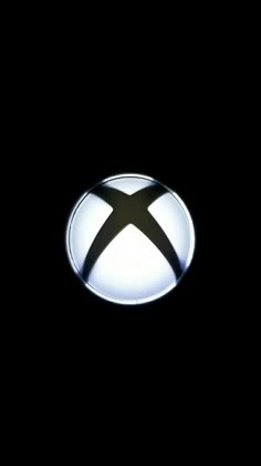 the xbox logo is lit up in the dark