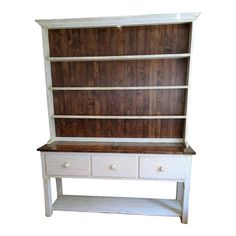 an old white dresser with drawers and shelves