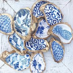 blue and white plates with pineapples on them sitting on a wooden table top