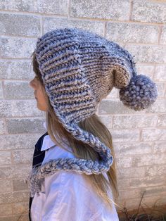 Fun and cozy slouchy, knit by me, beanie for the cooler fall and winter weather.  Ribbed knit split brim with smooth stockinette stitched body and large accent pom.  Yarn is a light gray color with small flecks of cream , tan, and dark brown.  80% acrylic and 20% wool blend. Care Instructions: Hand wash cold. Dry flat.  Carefully fluff/shake pom when dry to restore shape. Pattern: PixieBell Adjustable Knit Crochet Hat For Winter, Adjustable Knit Crochet Winter Hat, Warm Winter Bonnet With Curved Brim, Hand Knitted Brimmed Bonnet For Winter, Cozy Knit Bonnet, Hand Knitted Bonnet For Cold Weather In Fall, Adjustable Cozy Beanie Bonnet, Adjustable Soft Knit Cozy Bonnet, One Size Knit Bonnet For Fall