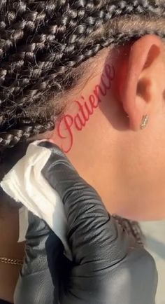 a woman with the word believe written on her ear