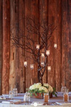 the centerpieces are made from branches and mason jars