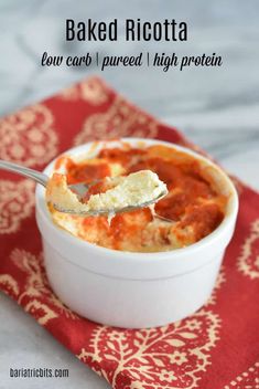 baked ricotta in a white bowl on a red and white napkin with a spoon