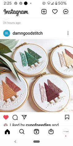 three cross stitch christmas trees in different colors and sizes on the same thread, one is red