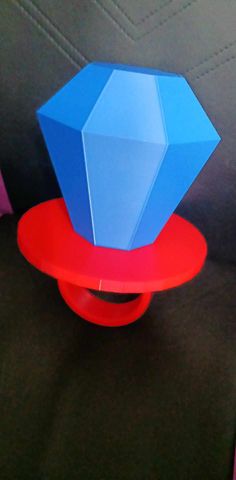 a blue and red object sitting on top of a black couch