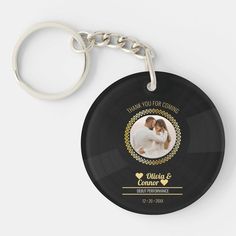 a black round keychain with an image of a bride and groom on it