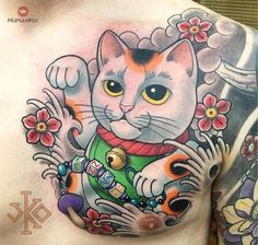 a man with a tattoo on his chest has a cat and flowers in it's chest