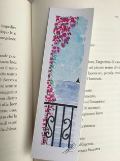 an open book with a watercolor painting on it