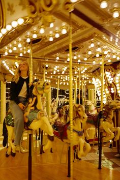 a woman sitting on top of a merry go round