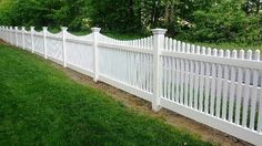 a white picket fence in the grass