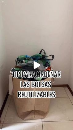 a pile of clothes sitting on top of a white tiled floor next to a wall