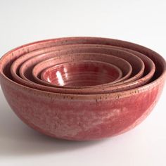 four pink bowls stacked on top of each other