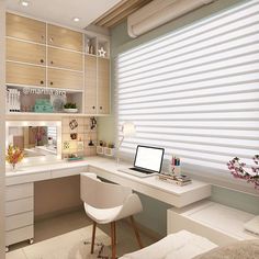 a white desk with a laptop on top of it next to a window covered in blinds