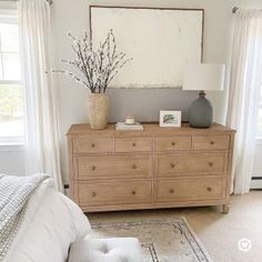 a bedroom scene with focus on the dresser and bed sideboard in the foreground