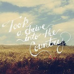 a field with the words, took a drive into the country written in cursive writing