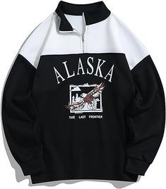 a black and white sweatshirt with the words alaska printed on it's chest, in front of an eagle