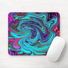 a mouse pad with an abstract design on it and a computer mouse next to it