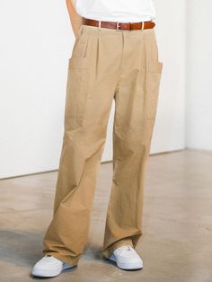 This is a comfortable and minimal cargo pants that are made out of high quality polyester 100% fabric. With design detail of loose silhouette and side pockets that gives a rough mood, it gives a casual and comfortable look. - Loose silhouette- Soft and sturdy polyester 100% fabric- Two tucks detail- Cargo pockets detail Khaki High-waisted Cargo Pants With Side Pockets, High-waisted Khaki Cargo Pants With Side Pockets, Beige Utility Cargo Pants With Straight Leg, Khaki High-waisted Utility Parachute Pants, Khaki High-waisted Parachute Pants With Pockets, Khaki High-waisted Cargo Parachute Pants, Baggy Beige Bottoms With Multiple Pockets, Solid Color Cargo Style Wide Leg Work Pants, Baggy Beige Pants With Pockets