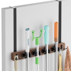 several different colored umbrellas are hanging on the wall next to towel racks and hooks