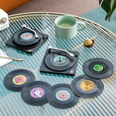 a table topped with lots of different types of vinyl records on top of each other