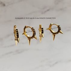 "Add punk-inspired glam to your lobes with these hoops with triple spikes and a row of black crystals. ♥ Available in gold and silver ♥ Gold / rhodium plated on the top of 925 sterling silver ♥ Available in 8 mm and 6 mm inner diameter ♥ Sold as single (ONE earring) or a pair ♥ Latch back ♥ Nickel free ♥ All items are packed inside an elegant Gold Spoon jewelry box. If you are purchasing a product to send as a gift, we can send the product directly to the recipient. Please ensure you write the r Earrings Edgy, Gold Spoon, Edgy Earrings, Hoops Silver, Hoops Gold, Earrings Everyday, Punk Inspiration, Spoon Jewelry, Spike Earrings