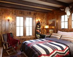 a bed in a room with wooden walls