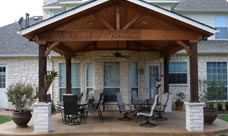 an outdoor covered patio with chairs and tables