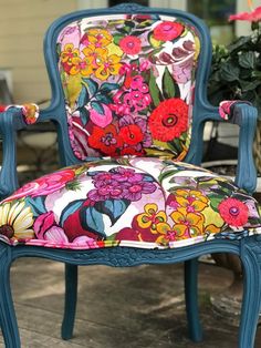 an old chair with colorful flowers on it