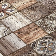 a close up view of an old wooden floor with different patterns and colors on it