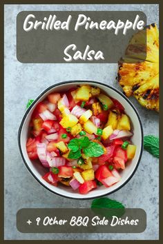 grilled pineapple salsa in a white bowl with green garnish on the side