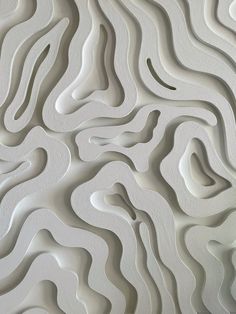 an abstract white wall with wavy lines on it