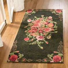 a rug with flowers on it in the middle of a floor next to a door