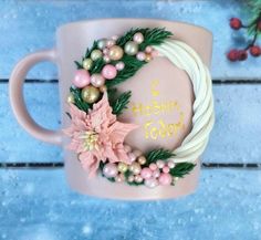 a pink coffee mug decorated with flowers and pearls