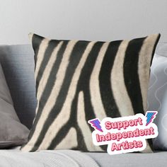 a black and white zebra print pillow with the words support independent artists on it's side