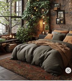 a large bed sitting under a window next to a green plant in a living room