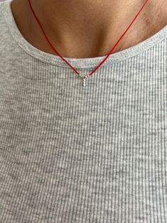 This handmade necklace features a striking combination of red cord, silver beads, and a single charm. The vibrant red cord serves as a bold base, contrasting beautifully with the elegant silver beads that add a touch of sophistication. The charm, carefully selected for its unique design, completes the piece, making it a standout accessory. Ideal for adding a pop of color and style to any outfit, this necklace is perfect for both casual and formal occasions. Its handcrafted nature ensures each pi Nylon Cord Necklace, Red String Necklace, Wish Necklace, Ear Cuff Jewelry, String Necklace, Minimal Necklace, Red String, Leather Corded Necklace, Protection Necklace