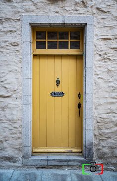 a yellow door on the side of a building