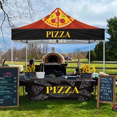 an outdoor pizza stand is set up in the grass