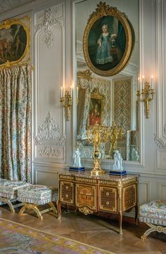 an ornately decorated room with paintings on the wall and furniture in front of it