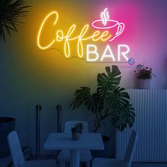 a neon sign that says coffee bar in front of a table with chairs and potted plants