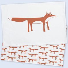 two napkins with foxes on them, one in orange and the other in white