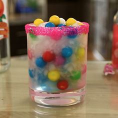 a small glass filled with candy on top of a table